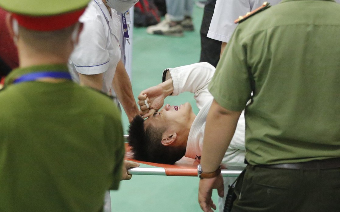 Hình ảnh vận động viên Jujitsu Indonesia ôm mặt đau đớn và phải rời sàn đấu trong trận đấu với Thái Lan